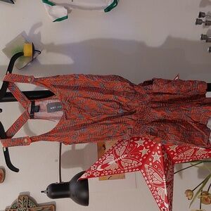 Coral and teal print romper with button snaps and pockets